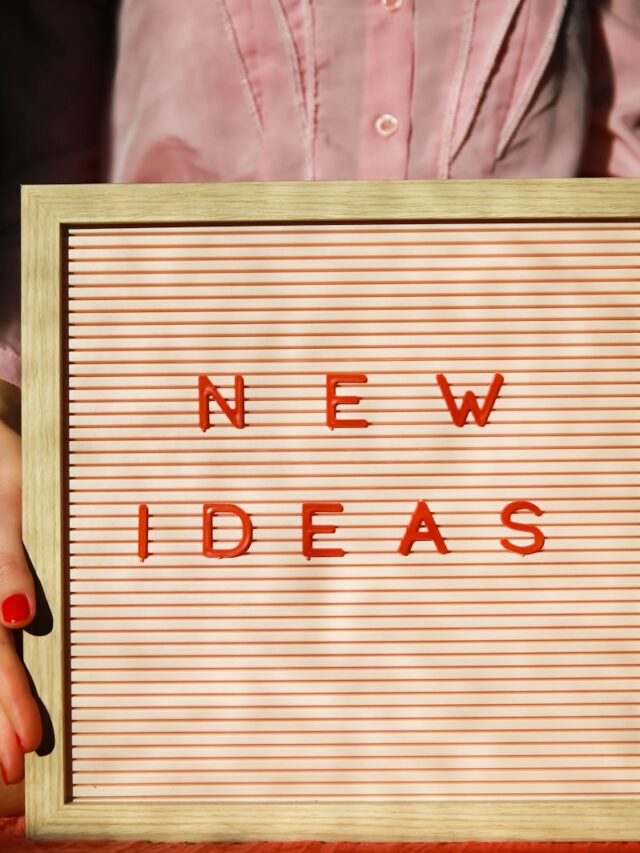 a person holding a sign that says new ideas