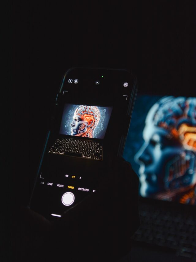 a cell phone sitting on top of a laptop computer