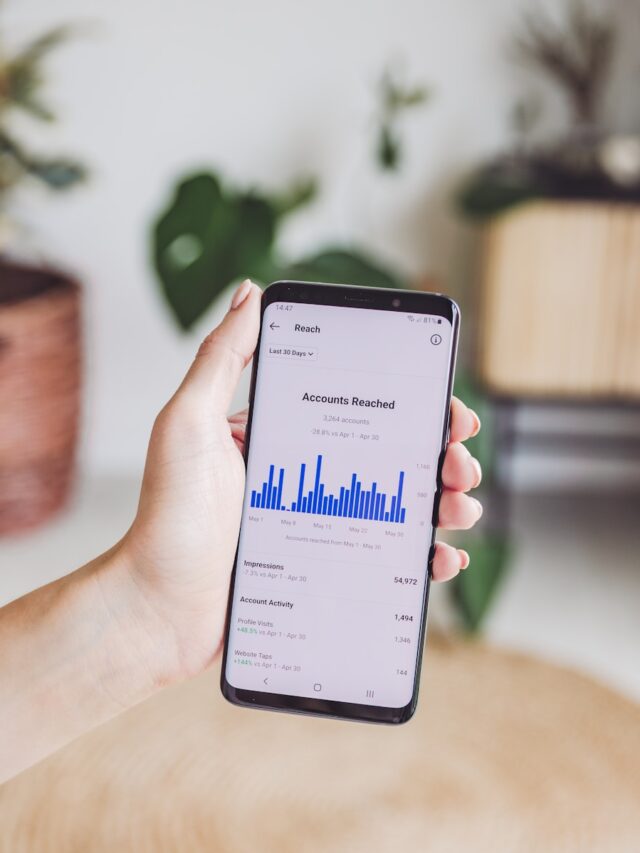 a person holding a cell phone in their hand