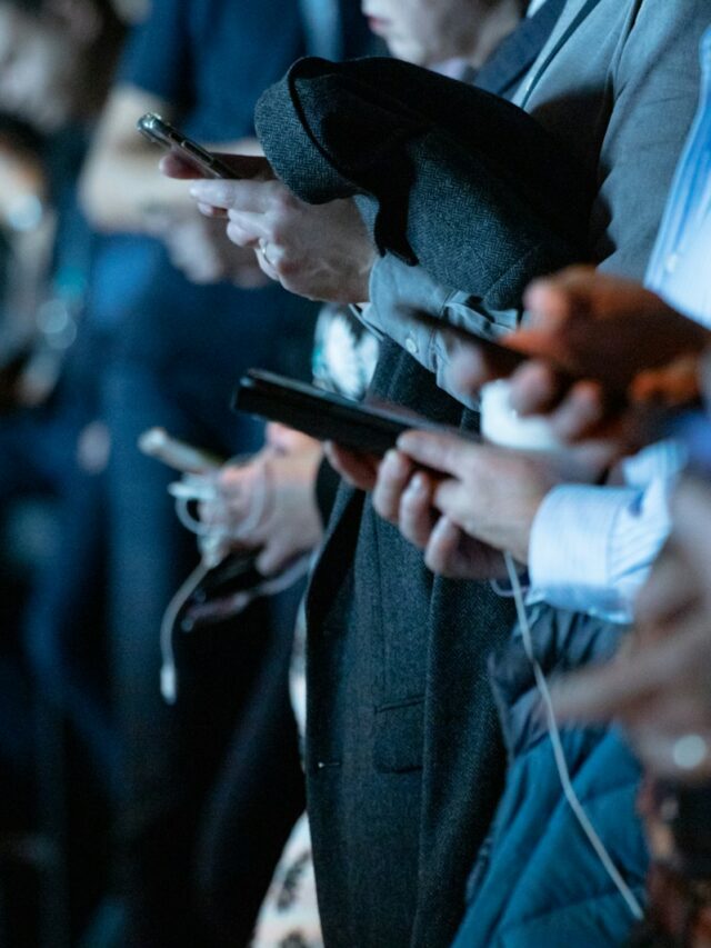 people using phone while standing